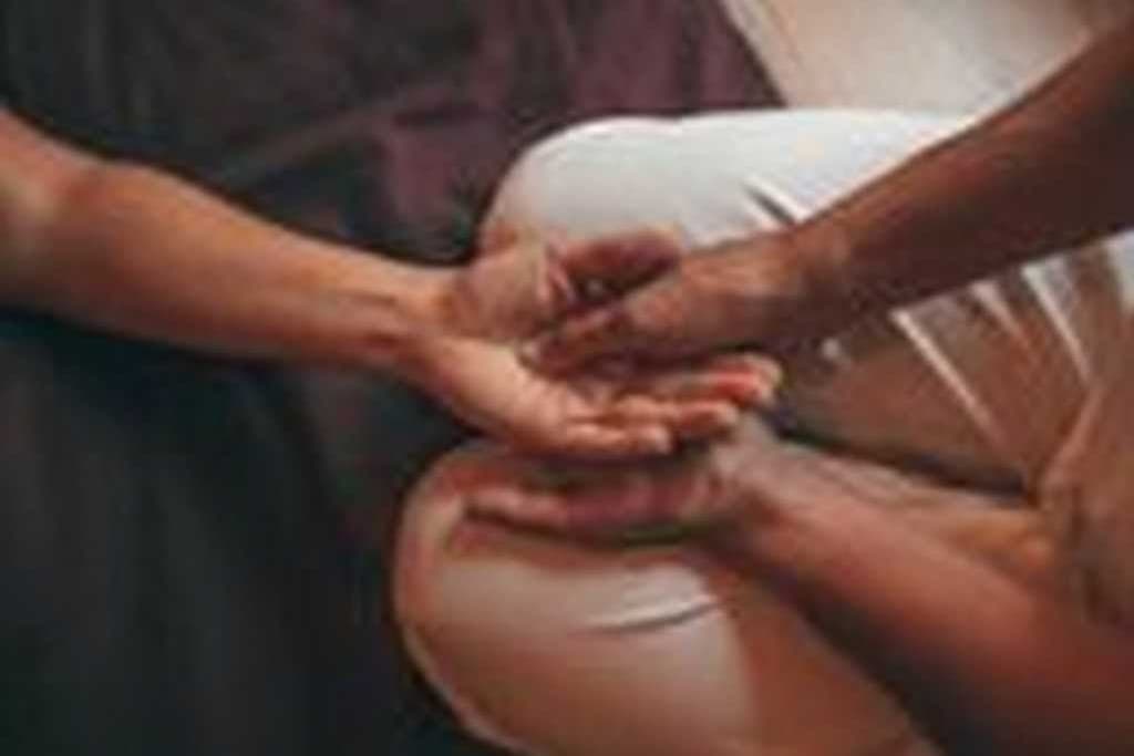 Bess taking a patient's pulse at the wrist